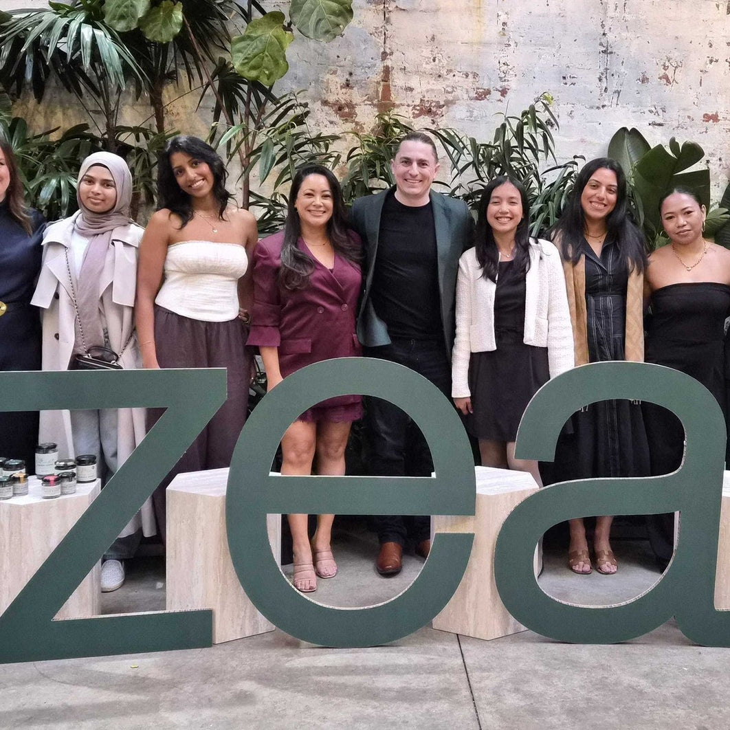 The Zea team at the company's tenth birthday celebration in 2026, standing behind large zea letters with products on display